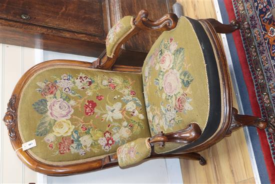 A large Victorian library armchair, upholstered in original needlework